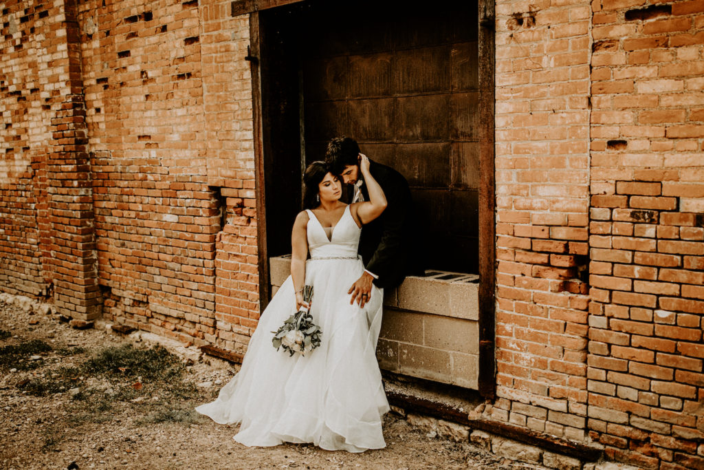 bride and groom next to historic building