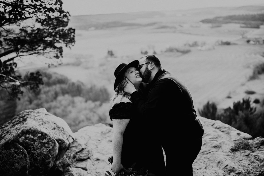 black and white of husband kissing wife while eloping in Wisconsin
