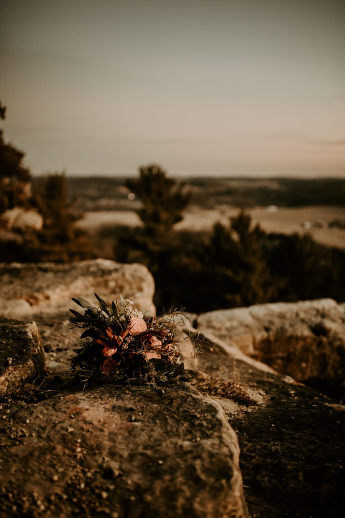 bridal bouquet sitting on Gibraltar rock overlooking Wisconsin valley
