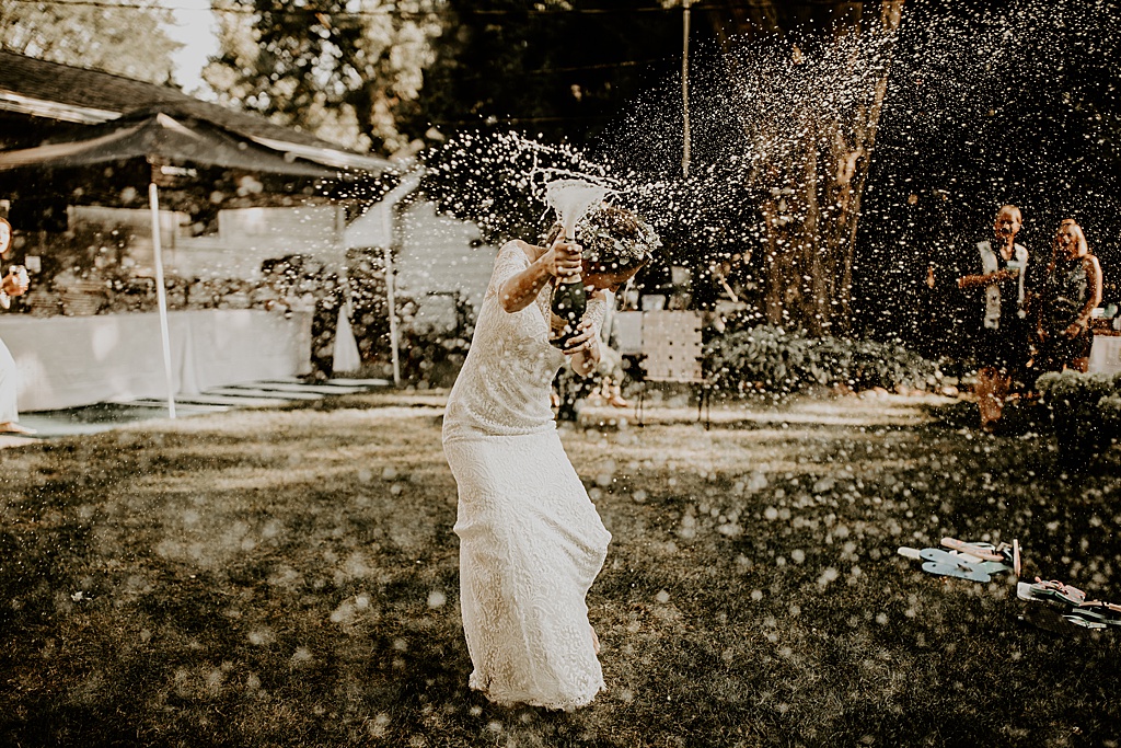 bride spraying champagne