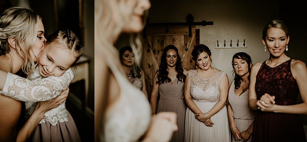bridesmaids smiling at flower girl while getting ready