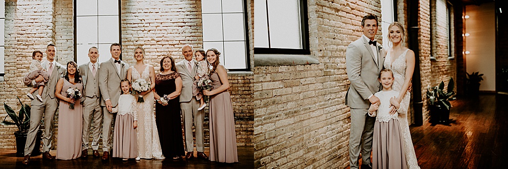 bridal party photo in brick building with large windows