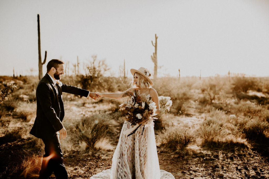 bride and groom dancing in Arizona desert during elopement