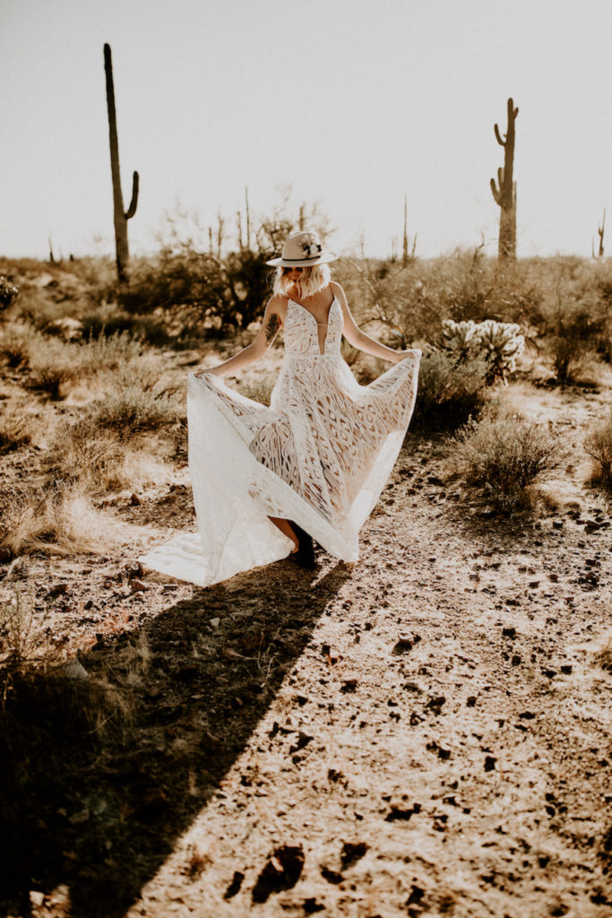bride in the Arizona desert sand and cactus in background