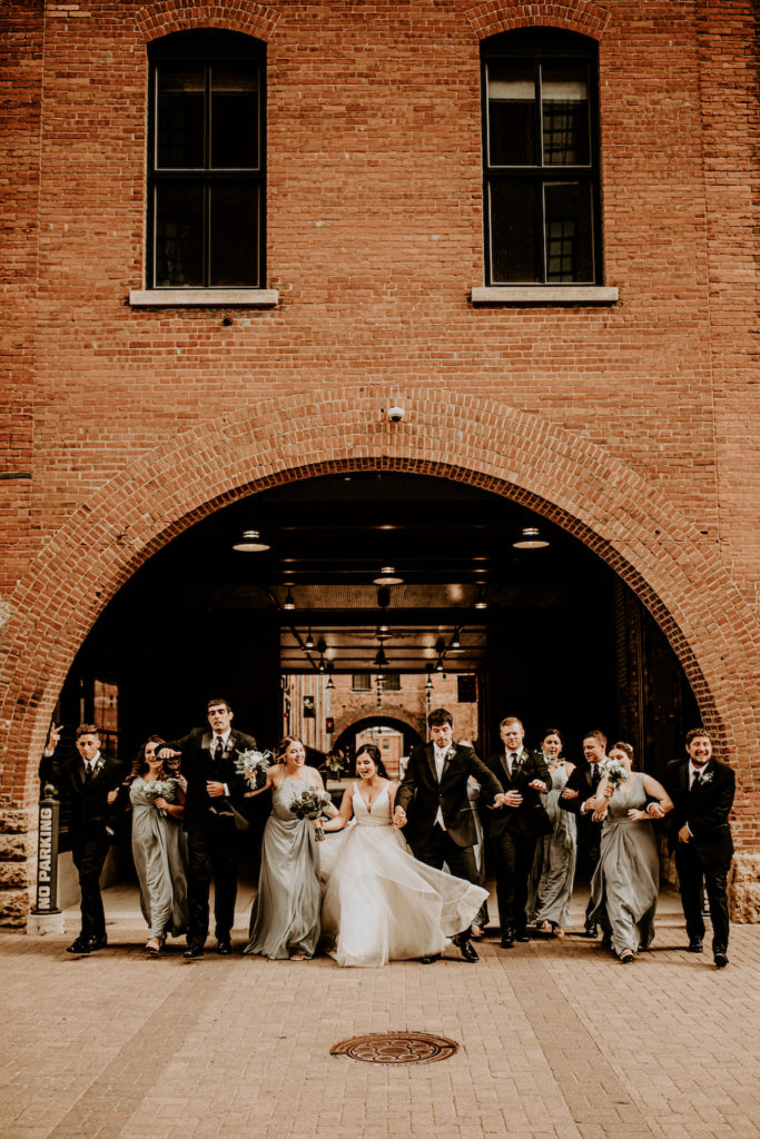 wedding part outside historical building under an arch