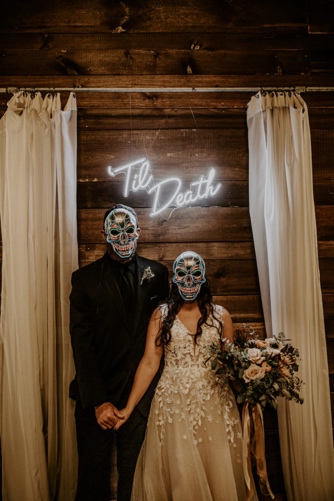 bride and groom with halloween skull masks
