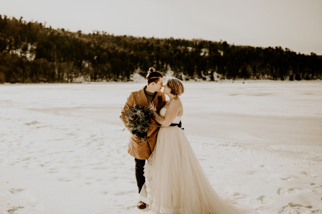 eloping vs wedding couple in an open field at winter