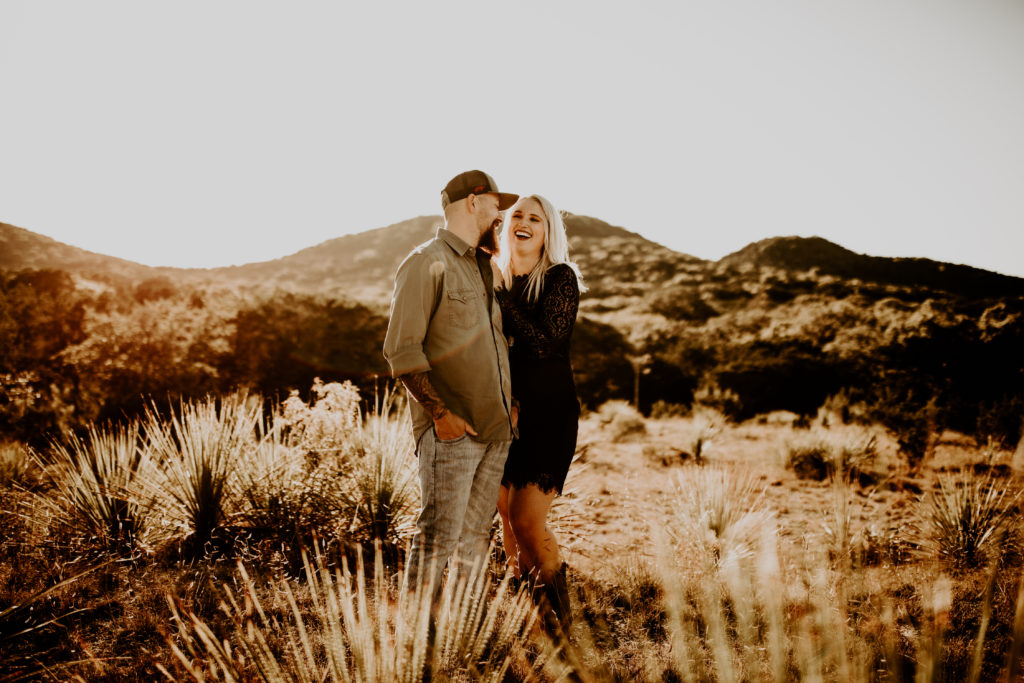 couple standing in the middle of the Texas desert during engagement photo shoot