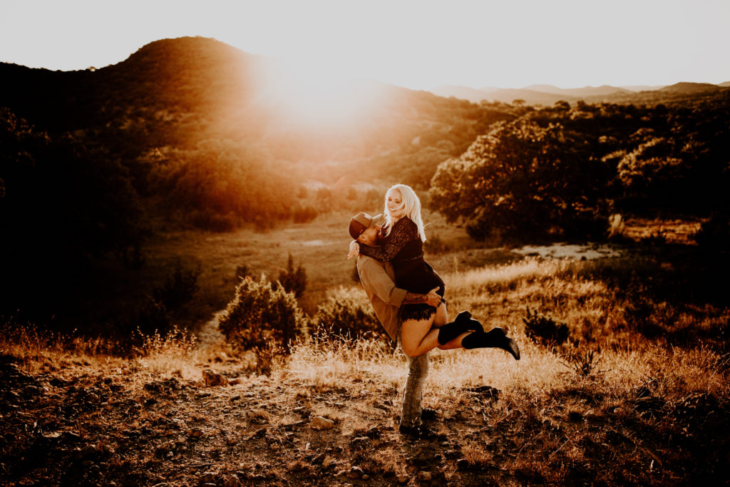 sunset engagement photos in the Texas desert with rolling hills in the background
