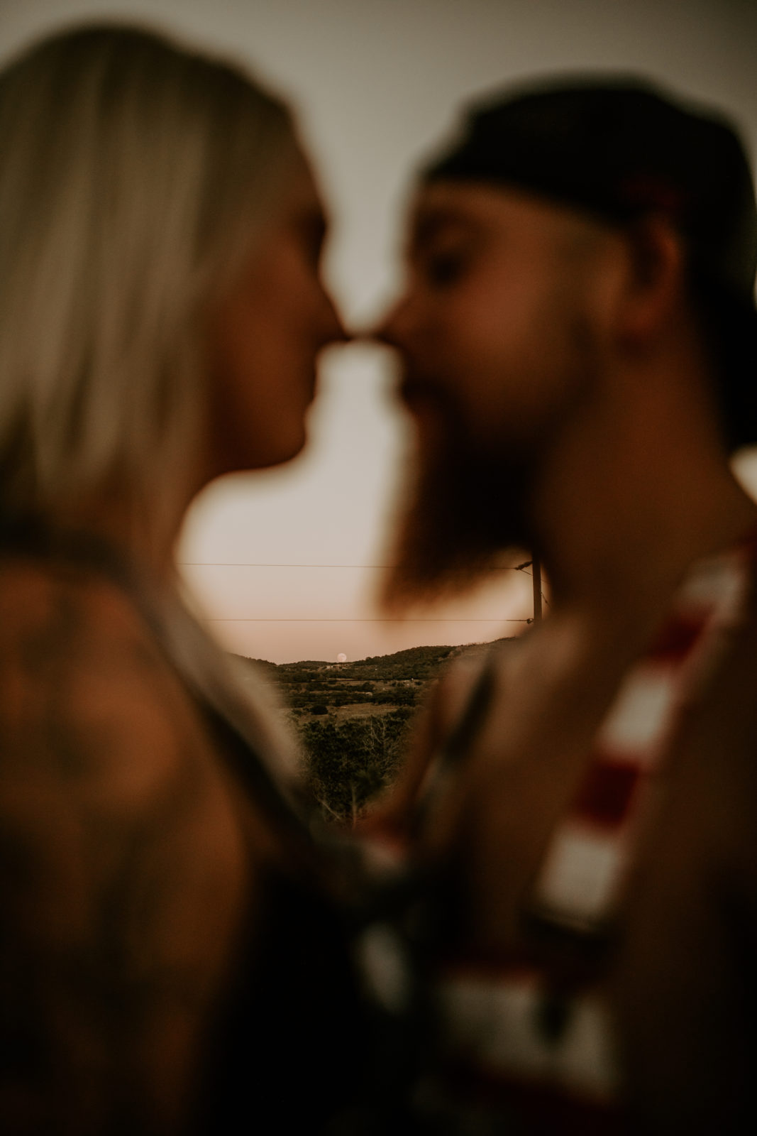 blurred close up photo of couple nose to nose with a clear photo between them of Texas desert