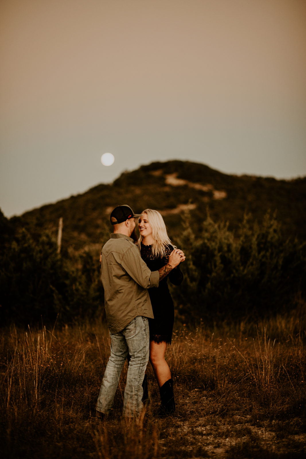 engagement session photos after sunset in front of Texas hill in the desert