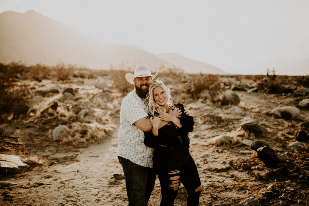 Joshua Tree desert engagement photos with mountains behind the couple