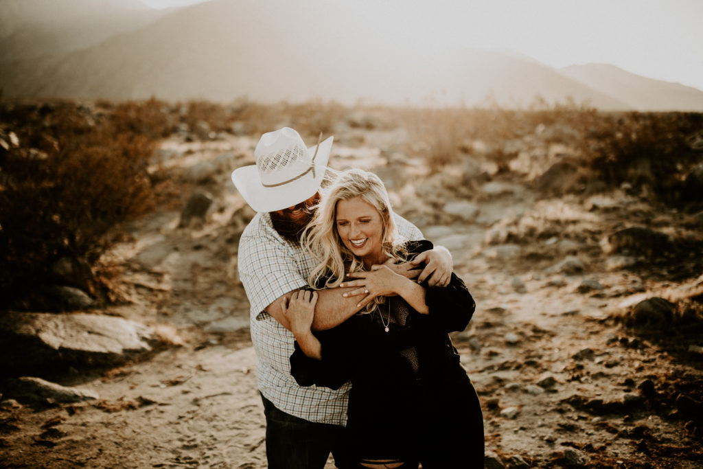 man and woman at joshua tree national park for desert engagement photos